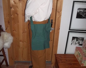 May include: A person wearing a white shirt and brown pants with a green canvas bag worn over the shoulder. The bag has a strap that goes over the opposite shoulder.