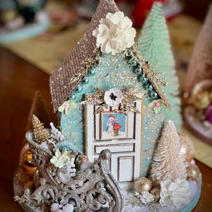 Beautiful teal Christmas house and sleigh