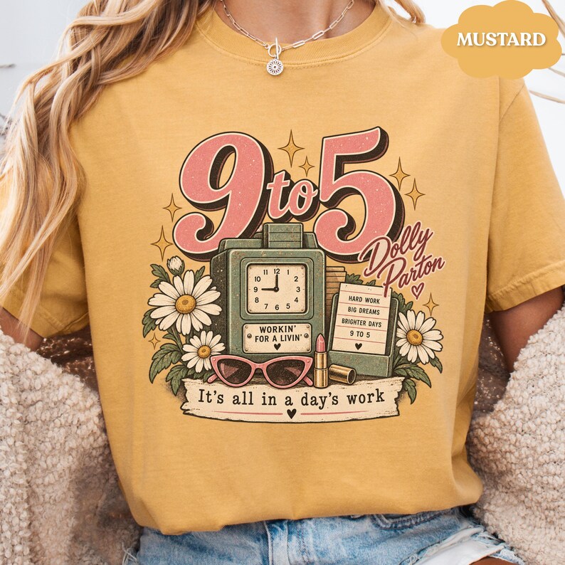 May include: A mustard yellow t-shirt featuring a graphic print with the text 9 to 5, Dolly Parton, and It's all in a day's work. The design includes a vintage clock, daisies, pink sunglasses, a lipstick tube, and a notepad with text.