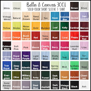 Puede incluir: Una carta de colores para camisetas de manga corta de color liso Bella & Canvas 3001. La carta muestra una variedad de colores, incluyendo blanco, amarillo, azul, verde y rojo, con nombres como "Mostaza", "Teal" y "Marina".