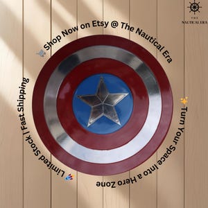May include: A Captain America shield with a red, silver, and blue design. The shield features a silver star in the center, surrounded by a blue circle, a silver ring, and a red outer ring. Text on the image says "Turn Your Space Into a Hero Zone".