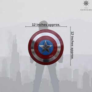 May include: A Captain America shield, approximately 12 inches (30 cm) in diameter. The shield features a red and silver concentric circle design with a blue star in the center. The Nautical Era logo is in the upper right corner.