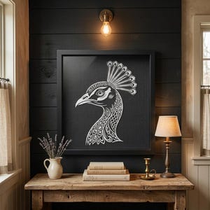 May include: A square black framed wall art piece featuring a white line art illustration of a peacock head in profile. The peacock has an intricate crest and detailed feather patterns on its neck, displayed against a textured black background.