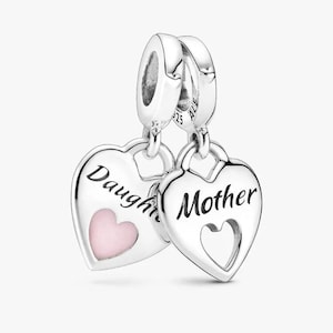 May include: Two silver heart-shaped charms. One charm says "Daughter" with a pink heart, the other says "Mother" with a heart-shaped cutout. Both charms are connected to a silver loop.