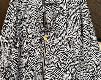Barely worn Michael Kors full zip blouse features a bold zebra print and a distinctive gold-tone zipper pull 3x
