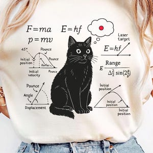 May include: Cream-colored t-shirt featuring a black cat illustration with physics equations and diagrams. The text includes "F=ma", "E=hf", and "p=mv". A thought bubble with a red dot is above the cat's head. The bottom of the shirt reads "PNG / DIGITAL FILE".