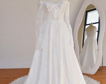 Vestido de noiva sexy em renda francesa: Cintura basca e ombros à mostra.