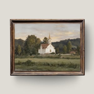 May include: A framed landscape painting depicts a white church with a red roof and steeple, set in a green field surrounded by trees. The artwork has a vintage aesthetic with a brown wooden frame.
