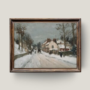 May include: A framed vintage painting depicts a snowy street scene. The artwork features a snow-covered road, buildings with snow-covered roofs, and silhouetted figures. The painting is in a wooden frame.