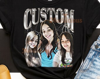 May include: Black t-shirt with a custom design featuring the word "CUSTOM" in a metallic, 3D style. The design includes three portraits of a person. The shirt is styled with denim shorts and tan sandals.