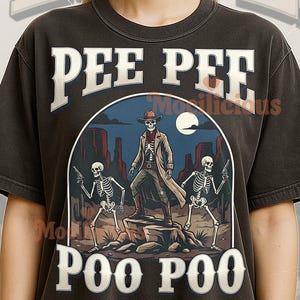 May include: Dark gray t-shirt with the words "PEE PEE POO POO" in white block letters. The graphic depicts a skeleton cowboy with two skeleton sidekicks in a desert scene.