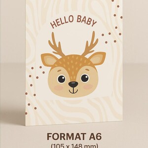 May include: A6 size baby announcement card with a cartoon deer illustration. The card features the text "HELLO BABY" above the deer's head. The card has a beige background with a swirl pattern and brown polka dots.