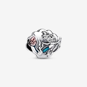 May include: A silver charm with a detailed design. The charm features a dragon, a pink rose, and blue accents. The charm is round and has intricate detailing.