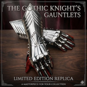 May include: A pair of polished metal gauntlets, part of a limited edition replica set. The gauntlets feature articulated fingers and are lined with red fabric. The text "THE GOTHIC KNIGHT'S GAUNTLETS" and "LIMITED EDITION REPLICA" are displayed.
