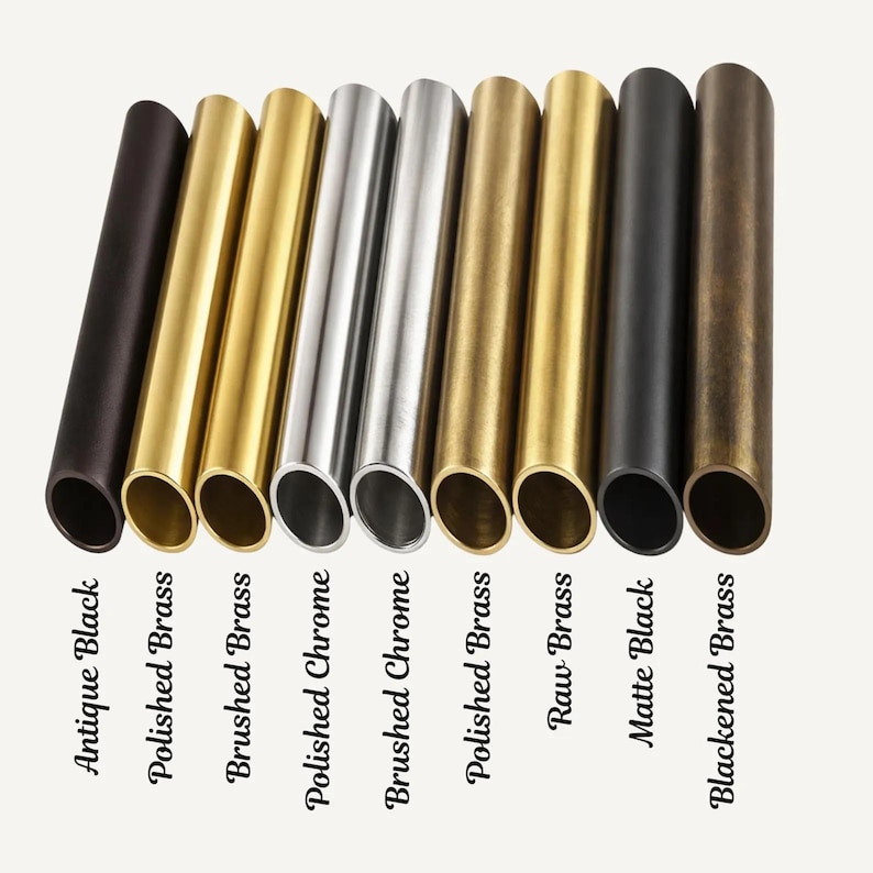 May include: Nine cylindrical metal tubes arranged in a row, showcasing various finishes labeled as Antique Black, Polished Brass, Brushed Brass, Polished Chrome, Brushed Chrome, Polished Brass, Raw Brass, Matte Black, and Blackened Brass.
