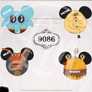 May include: Four cartoon character stickers with mouse ears, each with a name: Olivia, Peter, Riley, and Maddy. The stickers are in various colors, including blue, yellow, and orange. A decorative address plaque with the number 9086 is also visible.