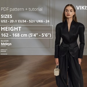 Op de afbeelding: Een vrouw draagt een zwarte blazer en een bijpassende broek met wijde pijpen. De blazer heeft een getailleerde pasvorm met een reverskraag en gestructureerde schouders. De afbeelding toont maten EU34-52 en een lengte van 162-168 cm.