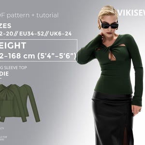 Può includere: Un top verde a maniche lunghe con un dettaglio a chiave, parte del modello "SADIE". L'immagine include la gamma di taglie (EU34-52), l'altezza (162-168 cm) e il livello di difficoltà. Il top è abbinato a una gonna nera.