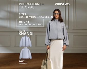 May include: A light blue zip-up jacket with long sleeves and a high collar, paired with a long cream skirt. The image includes text: PDF PATTERNS + TUTORIAL, VIKISEWS, SIZES US2-20, EU34-52, UK6-24, HEIGHT 162-168 CM (5'4"-5'6"), JACKET KHANDI.