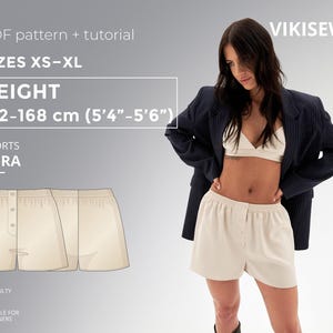 May include: A digital sewing pattern for "ABRA" shorts, sizes XS-XL, suitable for beginners. The pattern includes a tutorial and is designed for individuals 5'4"-5'6" tall. The image also features a woman wearing similar shorts.