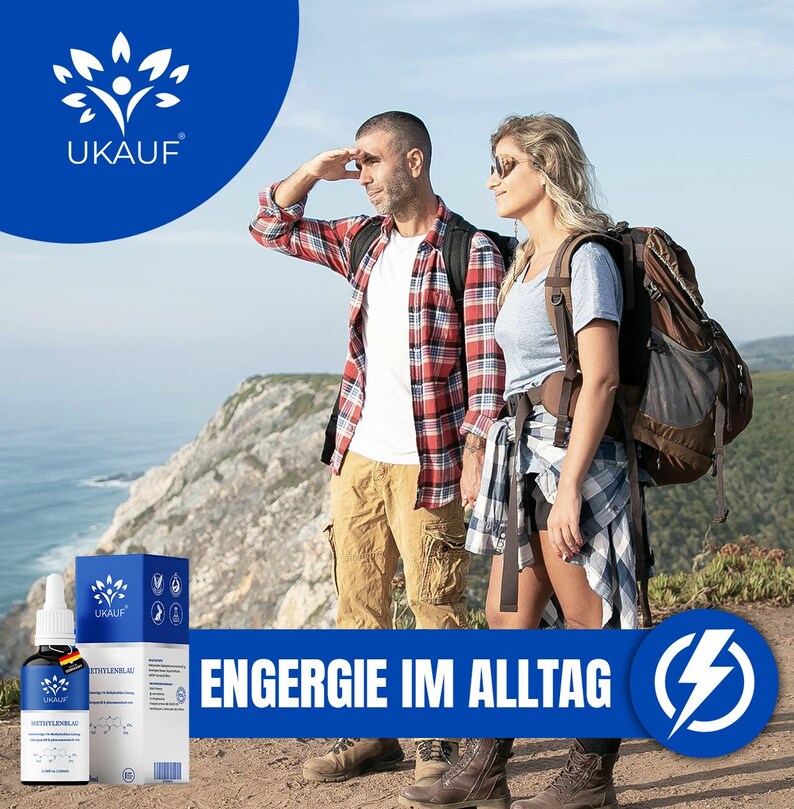 May include: A couple wearing backpacks stands on a cliff overlooking the ocean. The image includes a product shot of a bottle and box with the text "UKAUF" and "ENERGIE IM ALLTAG". The background is a blue sky and ocean.