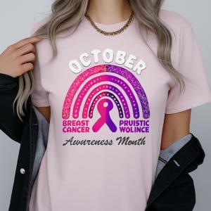 A woman wearing a pink t-shirt with a graphic design related to breast cancer awareness.