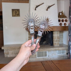 Vintage Spanish style metal spurs with large star-shaped rowels and decorative ironwork for Western horse tack collectors