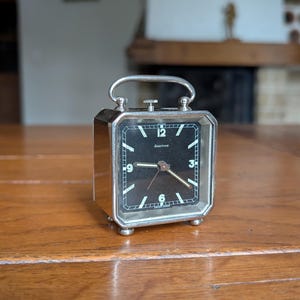 Looping Swiss vintage square wind-up chrome alarm clock for collectible gift or retro bedside display from Switzerland