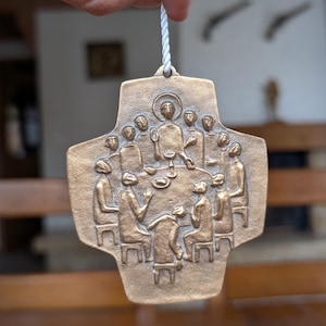 Vintage bronze wall cross with bas-relief depiction of the Last Supper in minimalist style for Christian home decor or religious gift