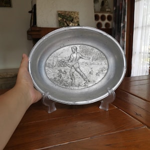 Vintage aluminum bread bowl with embossed farmer in the field motif for rustic kitchen decor or farmhouse collector display