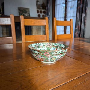 Chinese export porcelain punch bowl with rose medallion in the center with painted figures on verandas late 19th century