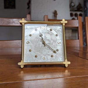 Swiss Made A Saint Eloi vintage brass mechanical clock with embossed ship image for table or pendant marine style decoration