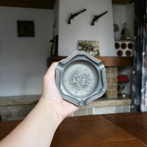 Frieling Zinn Germany vintage zinc ashtray for three cigarettes with embossed scene of man and woman meeting for rustic man cave decor