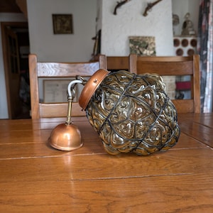 Vintage amber green blown glass pendant lamp in a mid-century Murano style metal cage from Italy