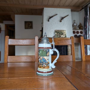 Schrobenhausen vintage German ceramic beer mug with zinc lid featuring Bavarian finger wrestling motif collectible stein from Germany