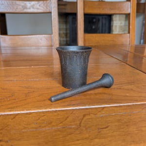 Von Roll antique Swiss cast iron mortar and pestle with textured finish from Balsthal for rustic kitchen or apothecary decor