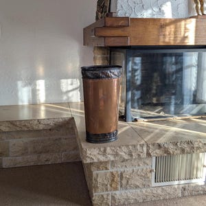Swiss vintage copper umbrella stand with hand chased alpine motifs and dark embossed panels for rustic entryway decor