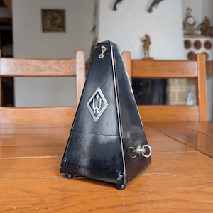 Wittner vintage mechanical metronome with black wooden pyramid case and precision movement made in Germany for musicians and collectors