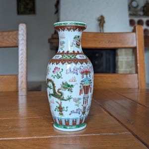 Qianlong period Chinese porcelain vase with hand-painted dragon and floral motifs and red seal for collectors