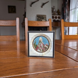 Antique hand-painted miniature portrait of a young man in round shape with square white wooden frame for classical interior wall decor