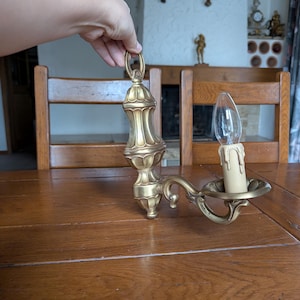 French vintage pair of cast bronze wall sconces with ornate curved Louis XV style design for classical interior lighting