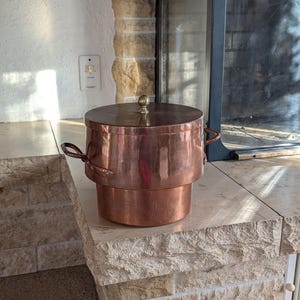 Copper vintage pot with Dutch oven style lid and twin brass handles for water bath cooking or rustic kitchen decor from Switzerland