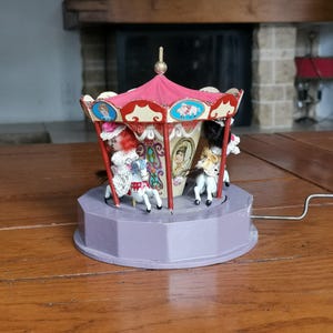 Antique handmade wooden mechanical musical carousel with 3 horses and 2 dolls on a stand and with a lid