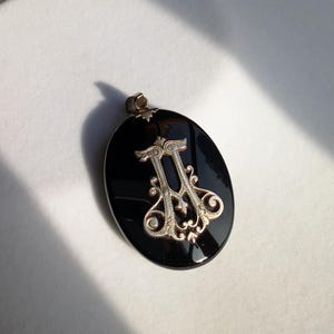 Antique French onyx mourning pendant locket with enamel and silver initial “M” in Victorian style memorial pendant