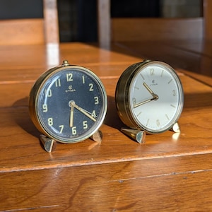 Cyma Swiss alarm clock vintage brass mechanical desk clock with choice of black or cream dial in mid-century style for elegant office decor