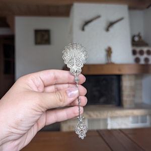 Vintage silver filigree spoon with ornate handle for elegant table setting or collectible flatware gift