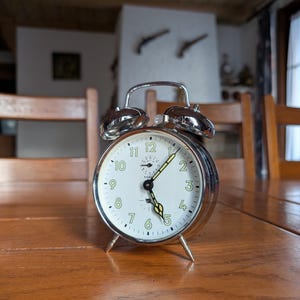 Kienzle German vintage winding desk alarm clock with chrome color mechanical clock and luminescent hands from Germany for office decor