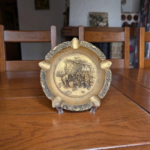 Large brass ashtray for 5 cigars with an embossed image of people as a gift for a smoker