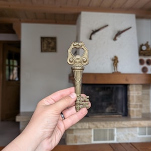 Vintage brass key-shaped bottle opener as a gift for beer lover and rustic bar decor
