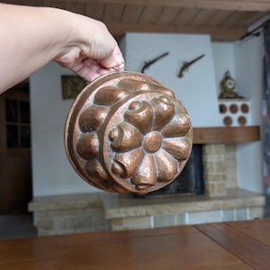 Vintage copper Gugelhupf cake mold with embossed floral design from Europe for rustic kitchen wall decor or farmhouse baking display